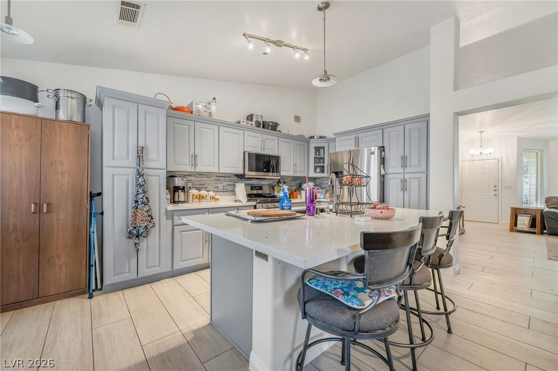 125 Heather Drive, Henderson, NV 89002 An expansive kitchen features an island, ample cabinetry, and modern hard surface flooring.