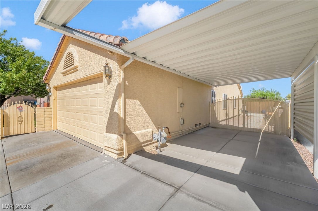 125 Heather Drive, Henderson, NV 89002 A spacious covered carport and detached garage offer extensive paved parking options.