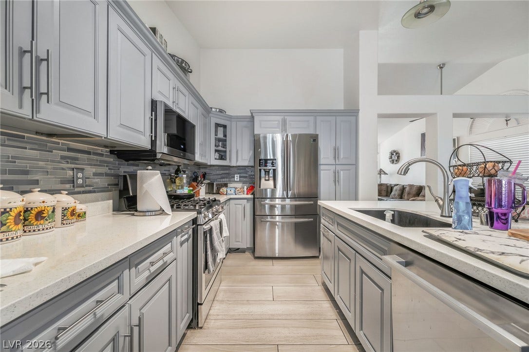 125 Heather Drive, Henderson, NV 89002 Gleaming stone countertops and matching cabinetry define this stylish galley kitchen layout.