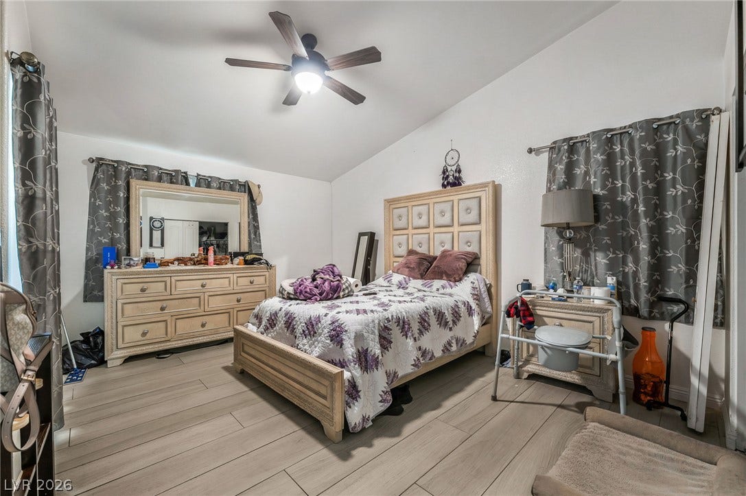 125 Heather Drive, Henderson, NV 89002 Vaulted ceilings and wood-look plank flooring elevate this comfortable sleeping space.
