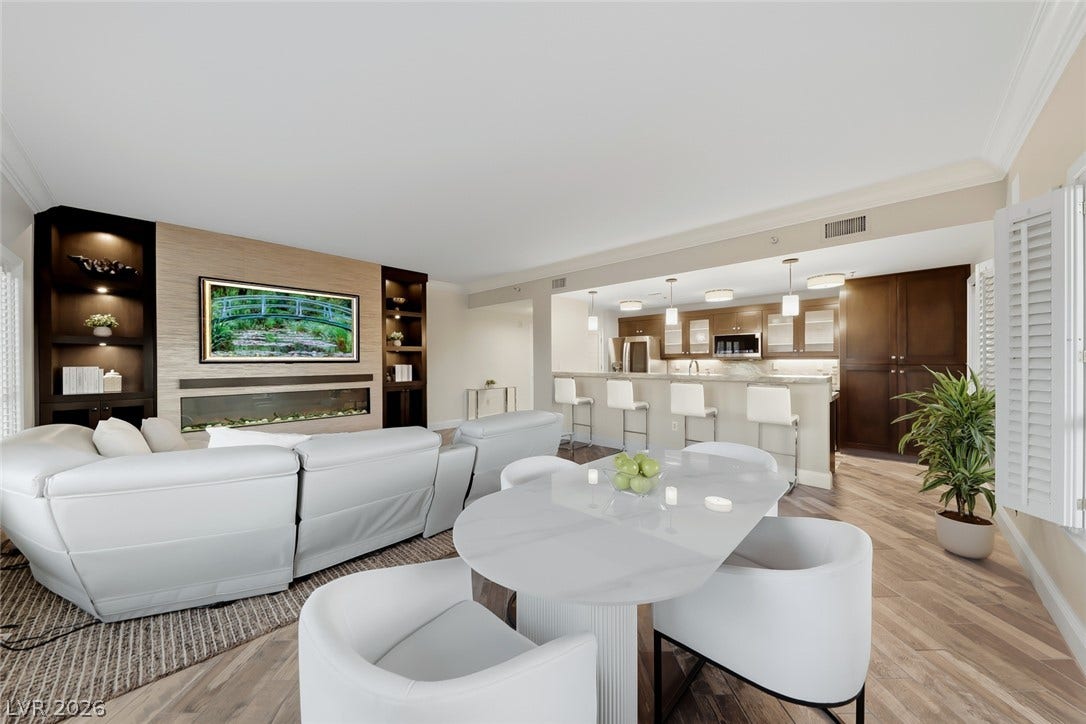 30 Strada Di Villaggio, #151, Henderson, NV 89011 Clean lines and a modern fireplace define this open living and dining area.