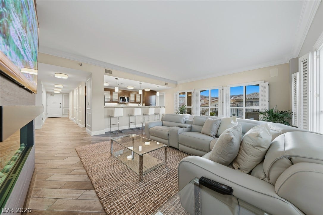 30 Strada Di Villaggio, #151, Henderson, NV 89011 Clean lines and warm wood-look tile floors define this airy open living area.