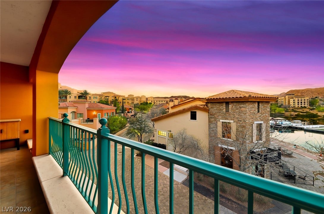 30 Strada Di Villaggio, #151, Henderson, NV 89011 Vibrant sunset skies frame the sweeping neighborhood and water views from this elevated balcony.