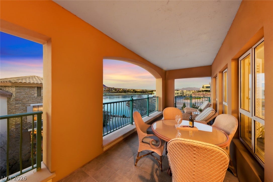 30 Strada Di Villaggio, #151, Henderson, NV 89011 An arched covered balcony offers serene water and neighborhood views.