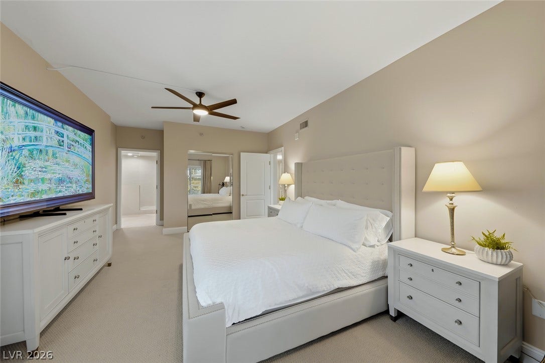 30 Strada Di Villaggio, #151, Henderson, NV 89011 Smooth neutral walls and neutral carpeting create a serene primary bedroom retreat.
