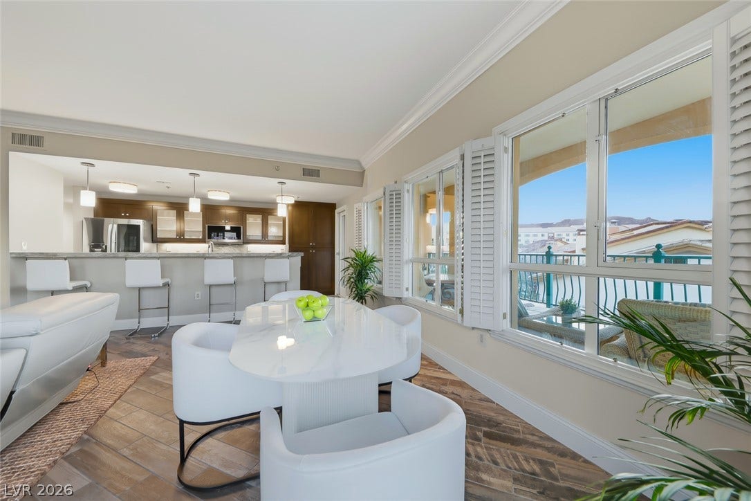 30 Strada Di Villaggio, #151, Henderson, NV 89011 Plentiful windows with plantation shutters frame an inviting dining space with wood-look tile floors.