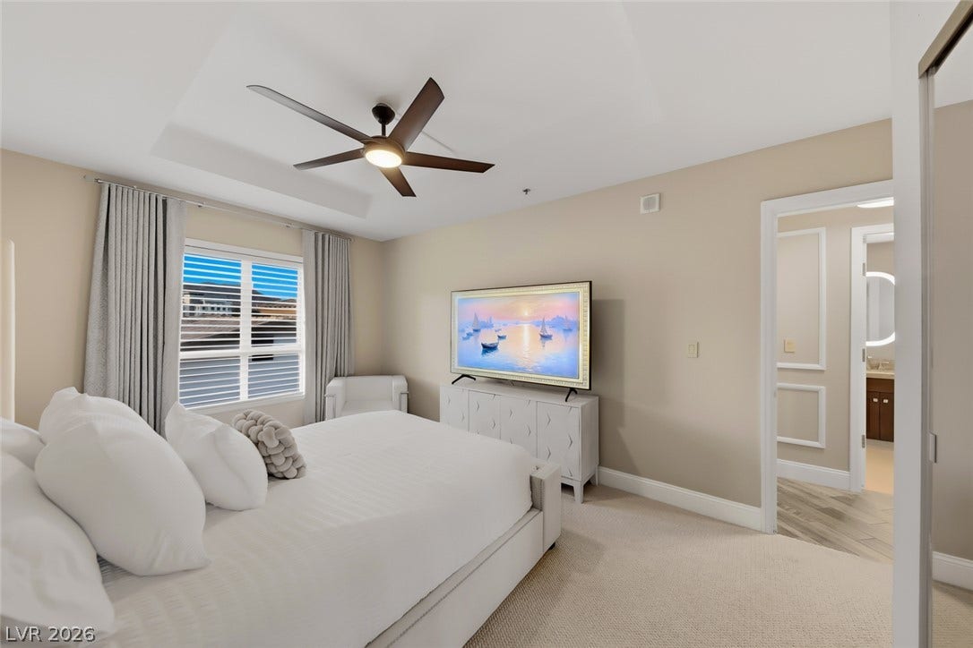 30 Strada Di Villaggio, #151, Henderson, NV 89011 High tray ceilings and soft carpeting create a tranquil atmosphere in this refined bedroom suite.
