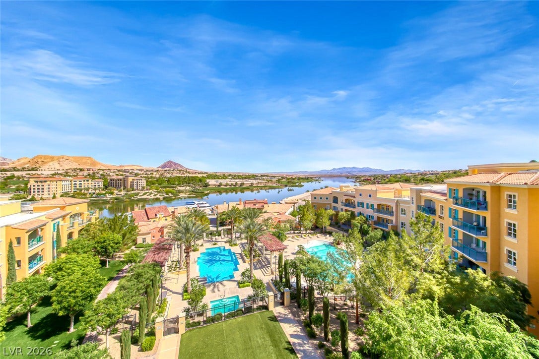 30 Strada Di Villaggio, #151, Henderson, NV 89011 Sweeping water vistas frame this elevated community perspective showcasing palm trees and resort-style amenities.