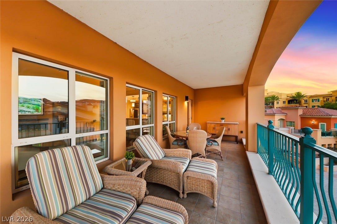 30 Strada Di Villaggio, #151, Henderson, NV 89011 A spacious covered balcony provides sweeping neighborhood views through an arched architectural opening.