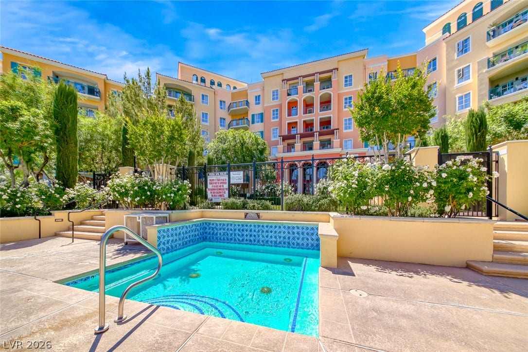 30 Strada Di Villaggio, #151, Henderson, NV 89011 A sparkling blue spa is surrounded by stone paving and lush landscaped gardens.