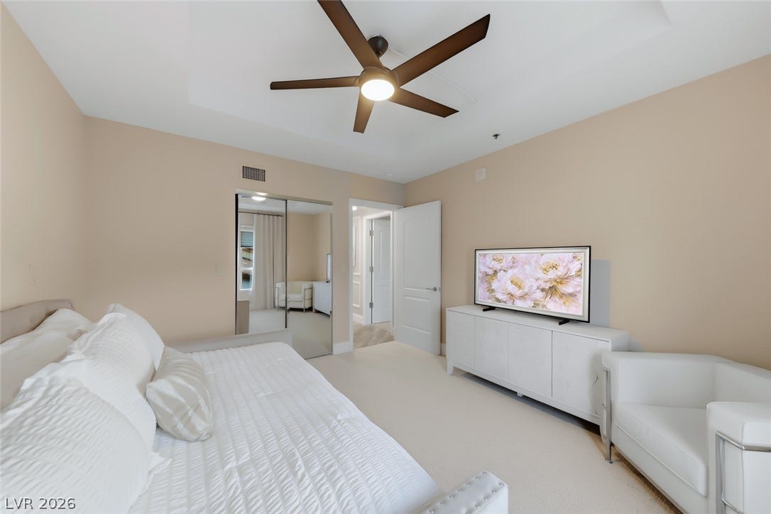 30 Strada Di Villaggio, #151, Henderson, NV 89011 Plush carpeting and a classic tray ceiling define this inviting bedroom space.