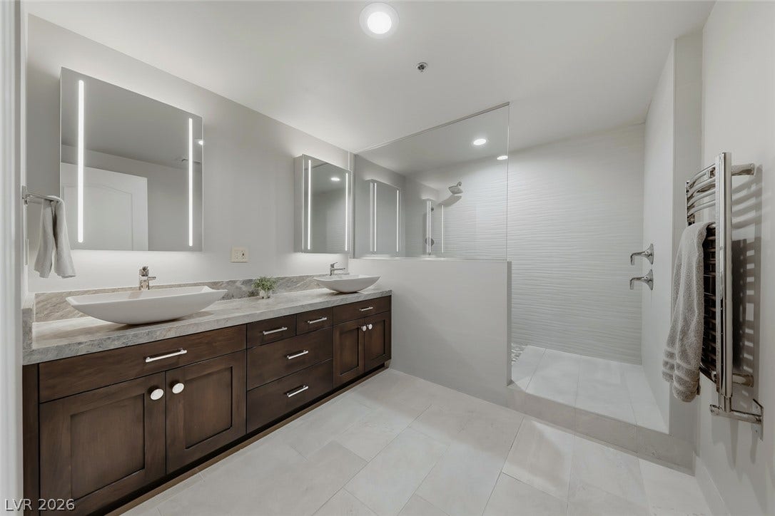 30 Strada Di Villaggio, #151, Henderson, NV 89011 A spacious double vanity and walk-in shower highlight this modern primary bathroom.