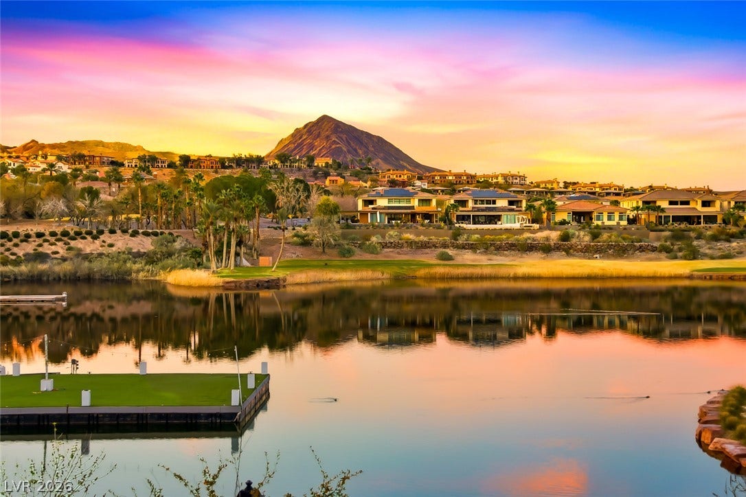 30 Strada Di Villaggio, #151, Henderson, NV 89011 Serene waterfront views showcase a quiet lake set against a dramatic desert mountain backdrop.
