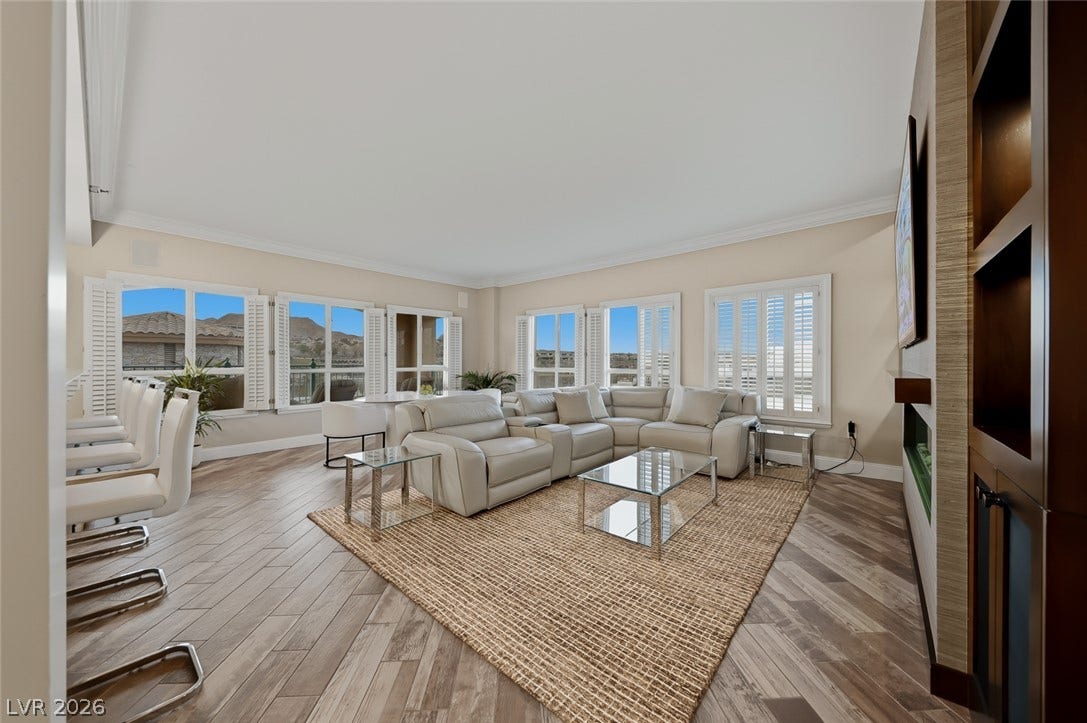 30 Strada Di Villaggio, #151, Henderson, NV 89011 Herringbone pattern floors and classic plantation shutters elevate this comfortable living space.