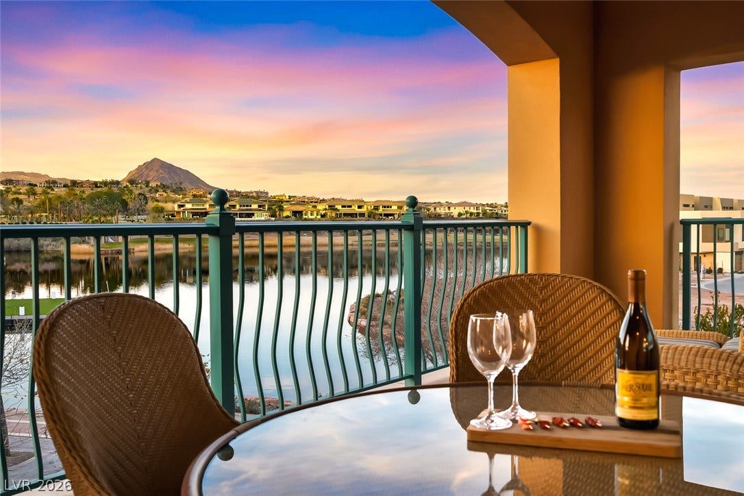 30 Strada Di Villaggio, #151, Henderson, NV 89011 A covered terrace overlooks the tranquil water and distant mountains.