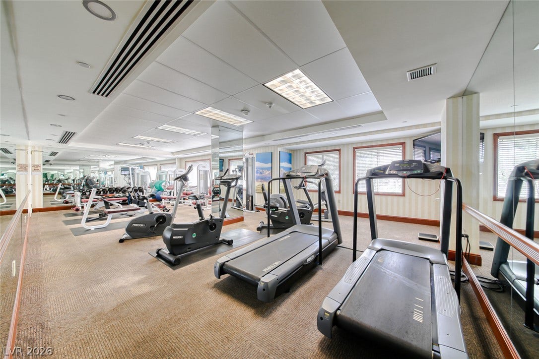 30 Strada Di Villaggio, #151, Henderson, NV 89011 Mirrored walls and recessed lighting complement the professional carpet tiles in this fitness area.