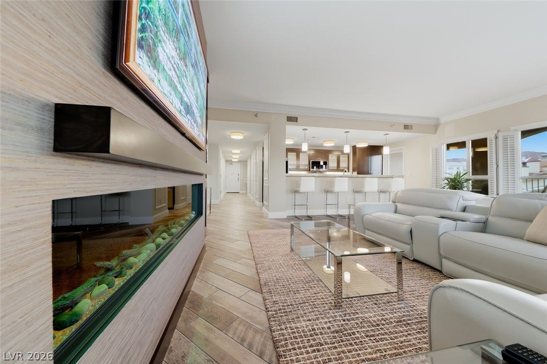 30 Strada Di Villaggio, #151, Henderson, NV 89011 Gleaming wood-look tile floors sweep through this modern, open-concept living space with built-in fireplace.