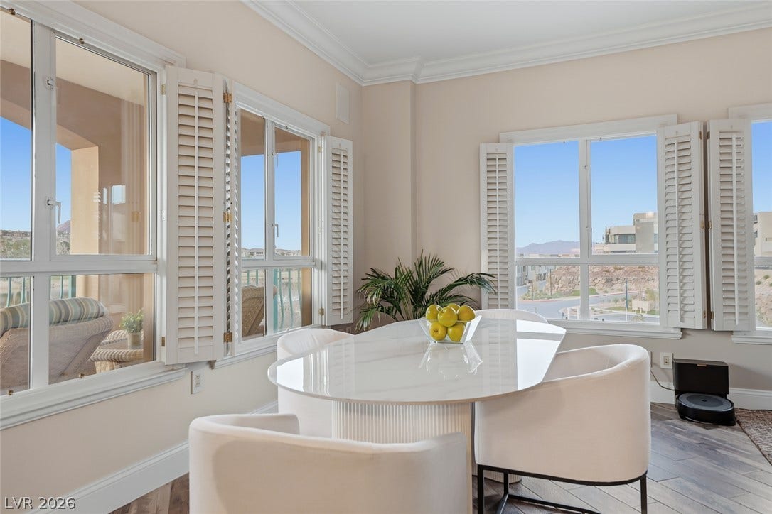 30 Strada Di Villaggio, #151, Henderson, NV 89011 Crown molding and plantation shutters frame views of the surrounding landscape in this dining area.