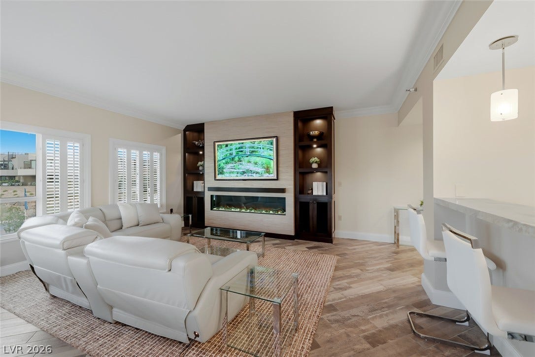 30 Strada Di Villaggio, #151, Henderson, NV 89011 Custom built-ins and a sleek fireplace anchor this airy space with wood-look tile floors.