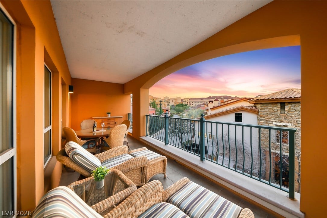 30 Strada Di Villaggio, #151, Henderson, NV 89011 A spacious covered balcony provides scenic neighborhood vistas framed by a graceful arched opening.