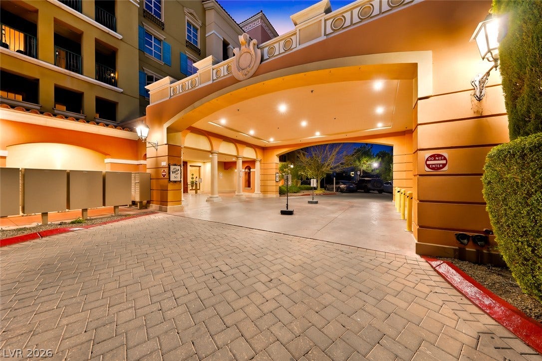 30 Strada Di Villaggio, #151, Henderson, NV 89011 A grand arched portico covers the paved driveway leading to a welcoming entrance foyer.
