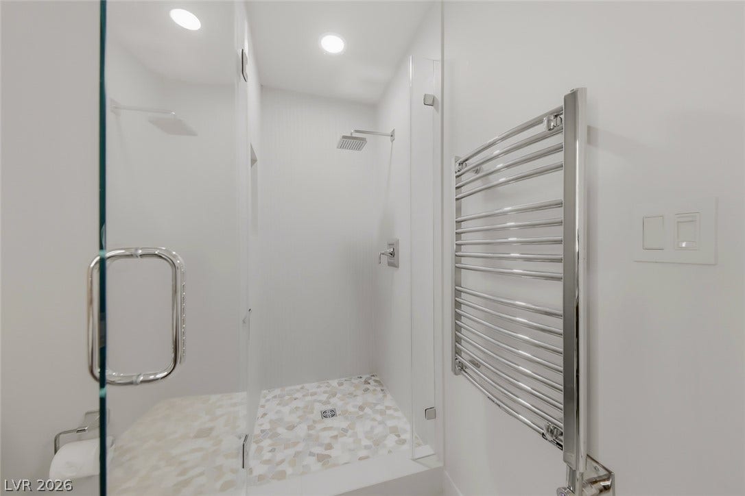 30 Strada Di Villaggio, #151, Henderson, NV 89011 Minimalist design defines this contemporary shower featuring a pebble tile floor and sleek glass enclosure.