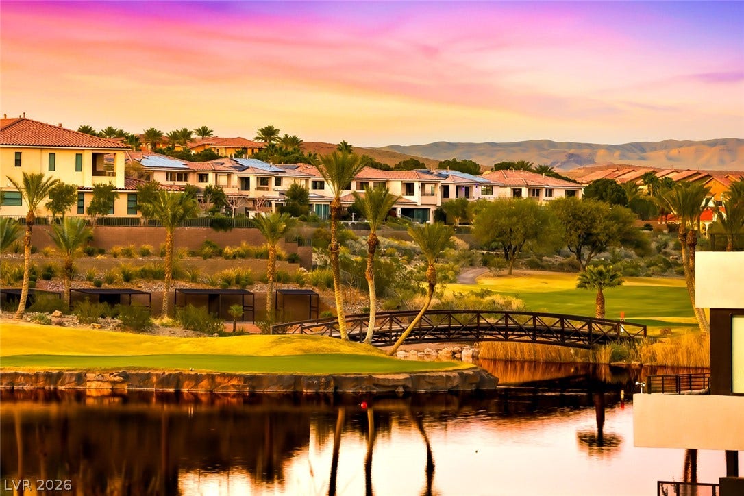 30 Strada Di Villaggio, #151, Henderson, NV 89011 A picturesque arched bridge arches over a calm water feature alongside manicured greensward.