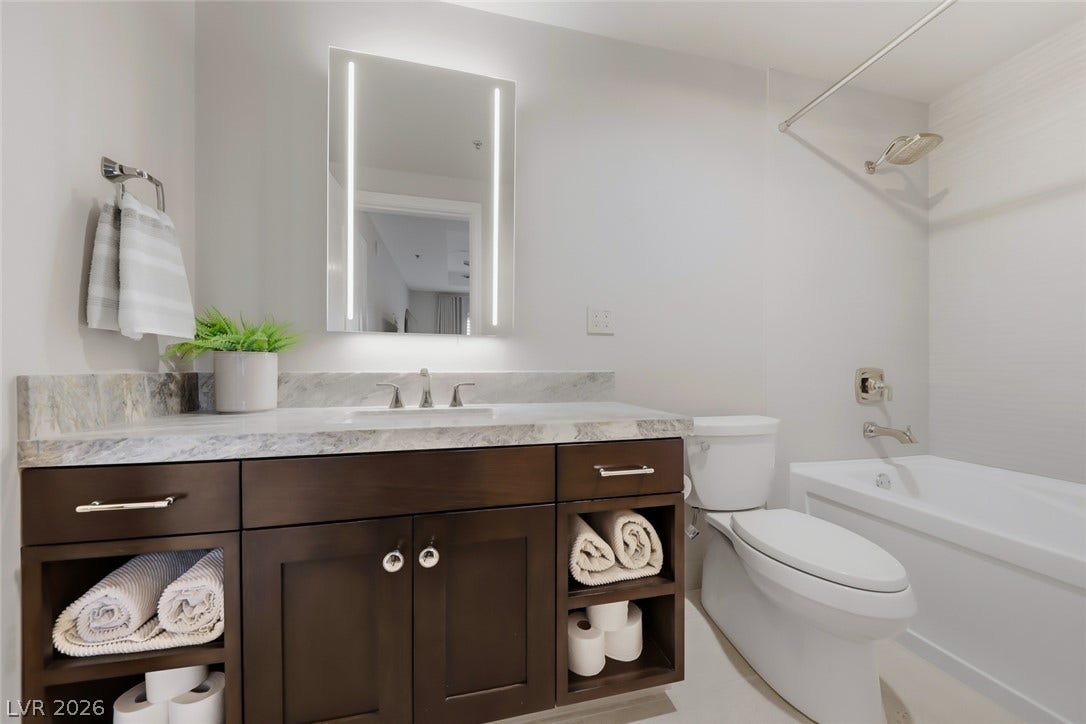 30 Strada Di Villaggio, #151, Henderson, NV 89011 A polished vanity with stone countertops highlights this contemporary bathroom design.