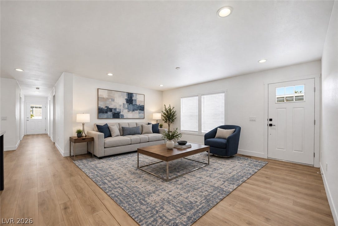 Smooth wood floors flow throughout this inviting main entry and living space.