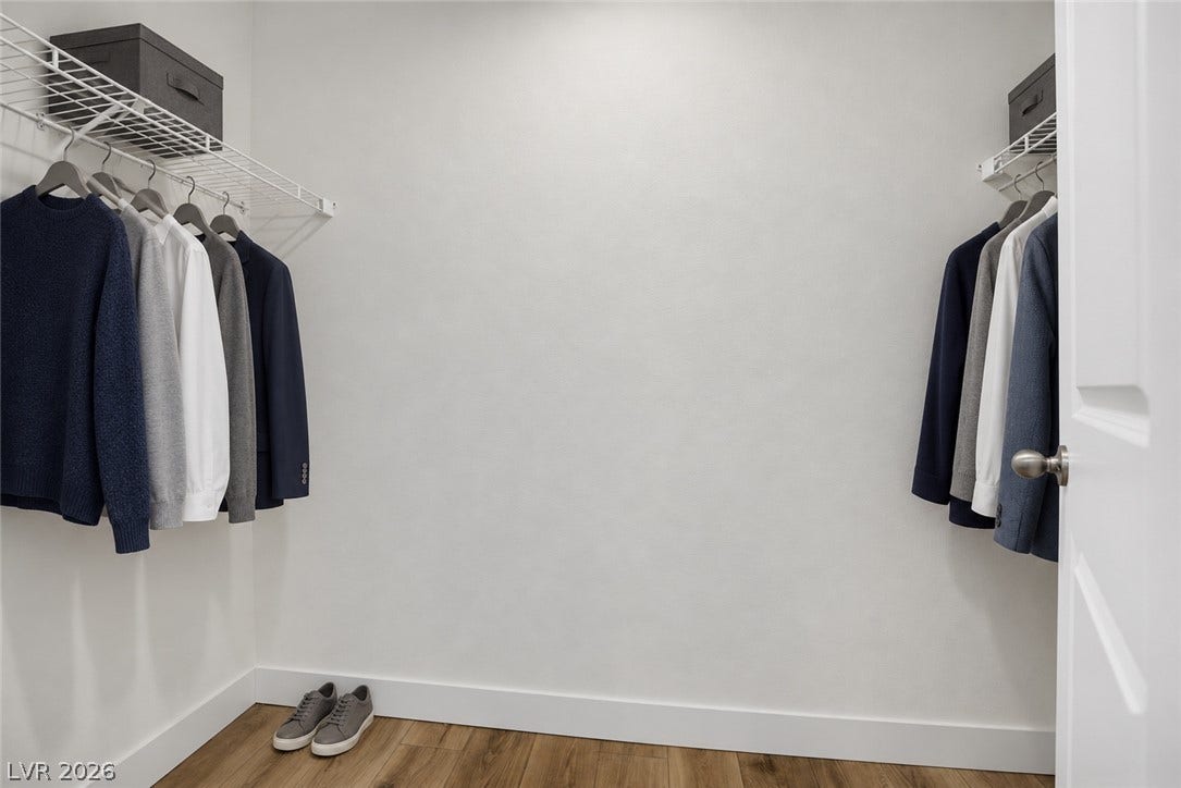 Ample hanging rods and shelving maximize storage space in this walk-in closet.
