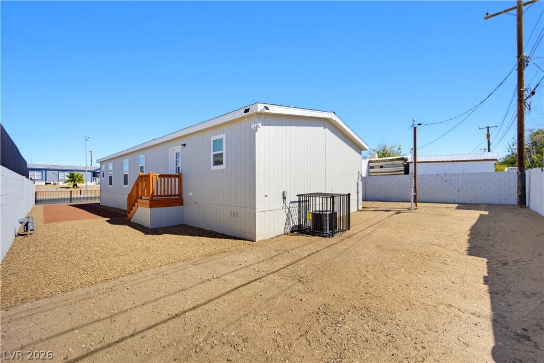 Clean vertical siding and a neat gravel yard define this low-maintenance exterior space.