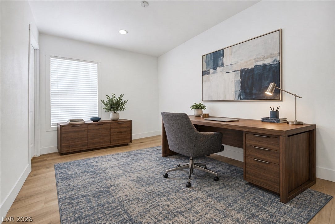 Smooth wood floors and recessed lighting establish a clean architectural canvas in this workspace.