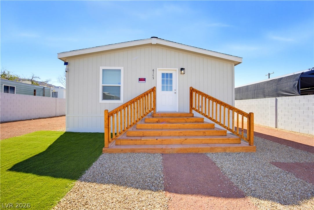 Sturdy wooden steps lead to the welcoming front entrance of this modern home.