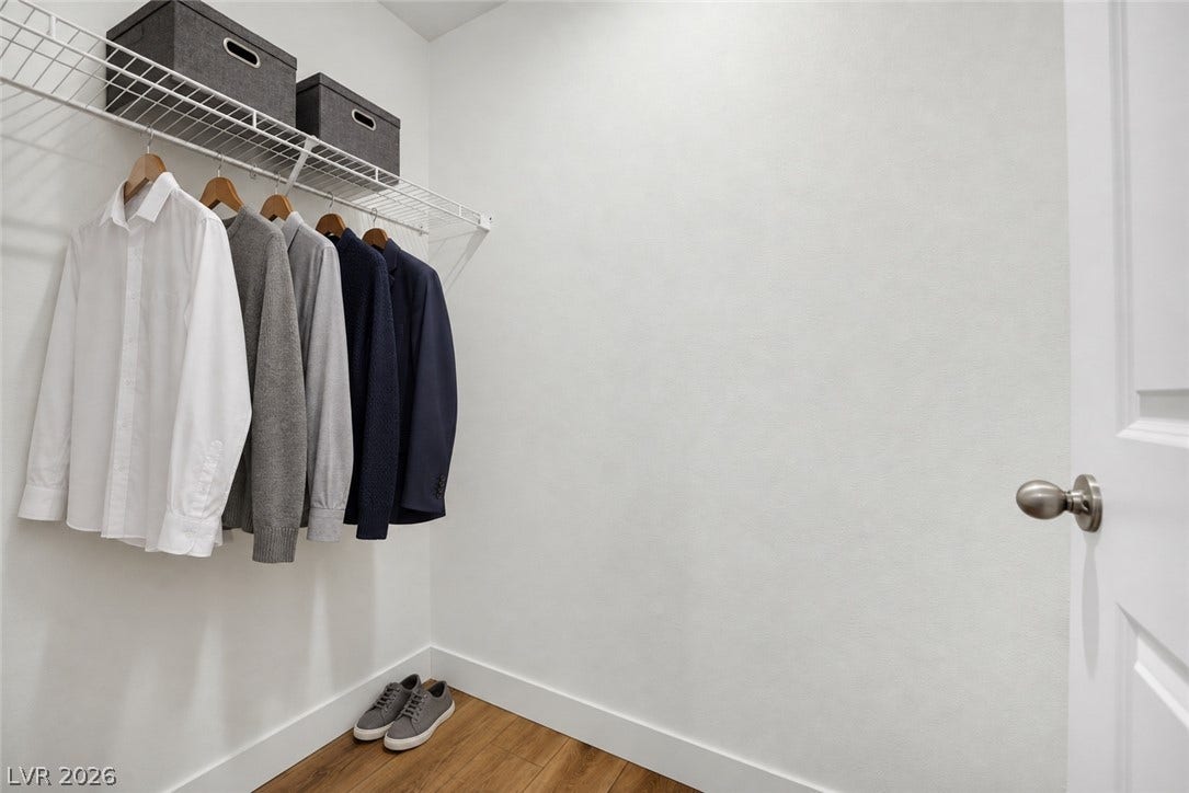 Ample wire shelving and rich wood flooring define this functional storage space.