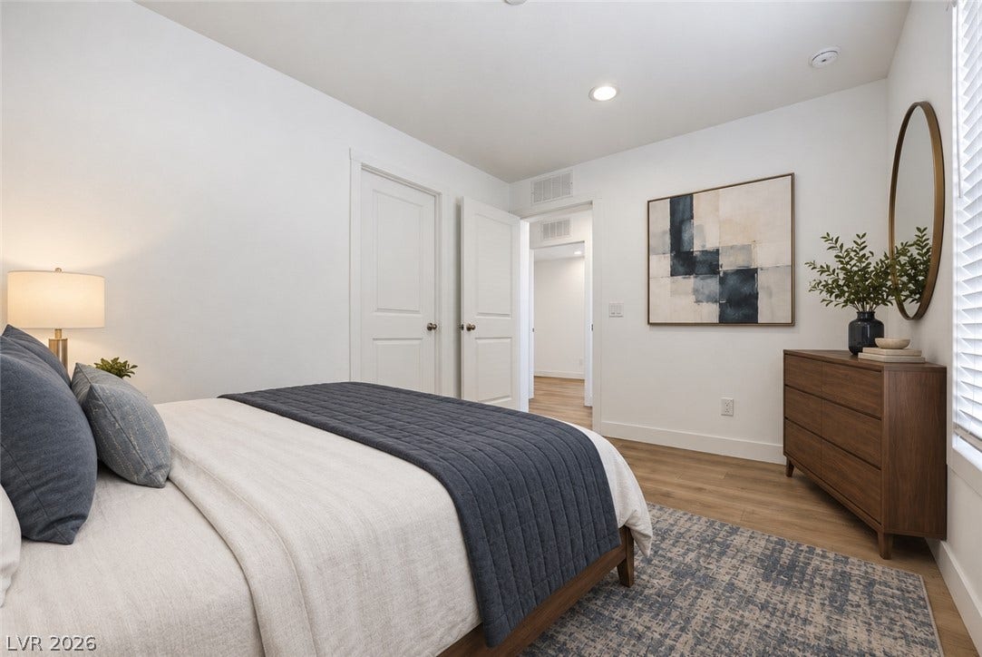 Smooth wood floors and crisp white walls create a serene, minimalist retreat.