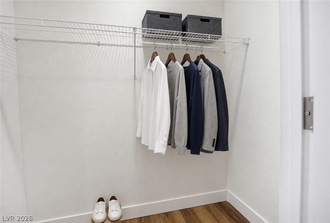 Ample wire shelving and rich wood flooring define this organized storage space.