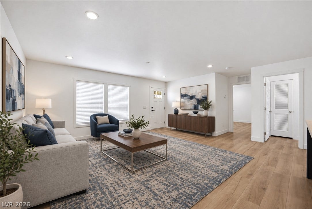 Warm wood floors and recessed lighting enhance this airy main-level living space.