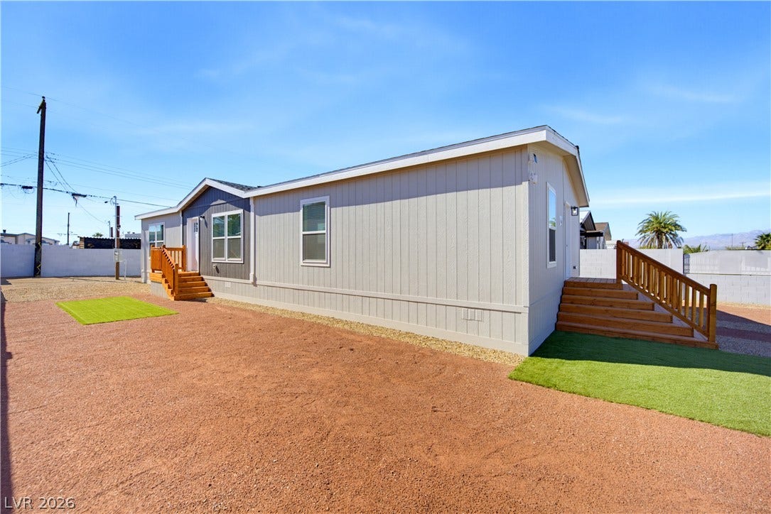 Board and batten siding creates an appealing exterior profile under a clear desert sky.