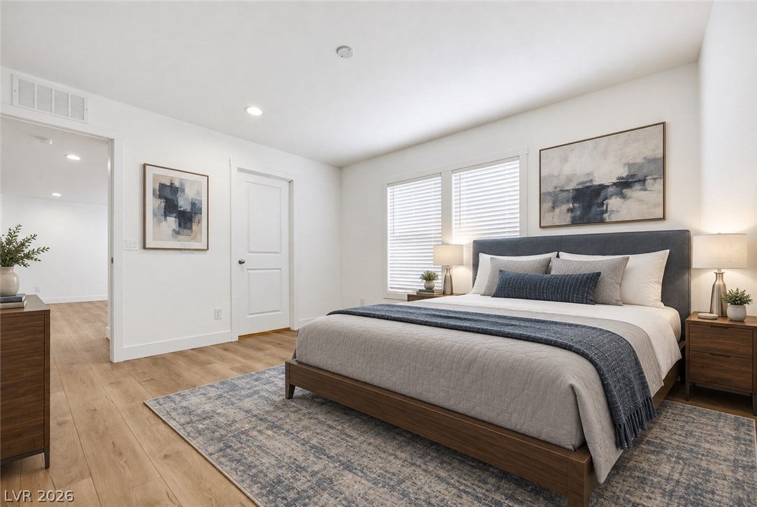 Warm wood floors and smooth walls create a serene atmosphere in this bedroom.