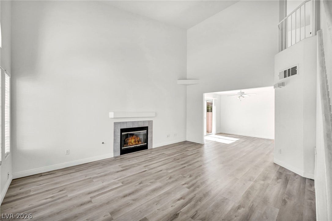 511 Armenian Place, Henderson, NV 89052 Dramatic high ceilings and a classic fireplace define this airy living space.
