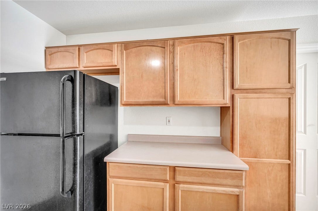 511 Armenian Place, Henderson, NV 89052 Ample wooden cabinetry provides excellent storage space alongside durable countertops.