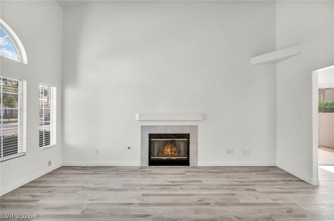511 Armenian Place, Henderson, NV 89052 High ceilings and a fireplace anchor this airy, light-filled living space with wood-look flooring.