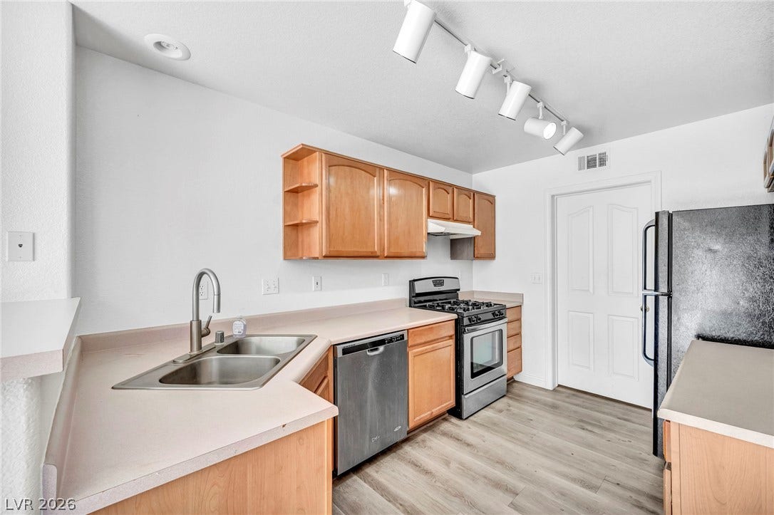 511 Armenian Place, Henderson, NV 89052 Functional kitchen design showcases warm wood cabinetry alongside resilient wood-look flooring.
