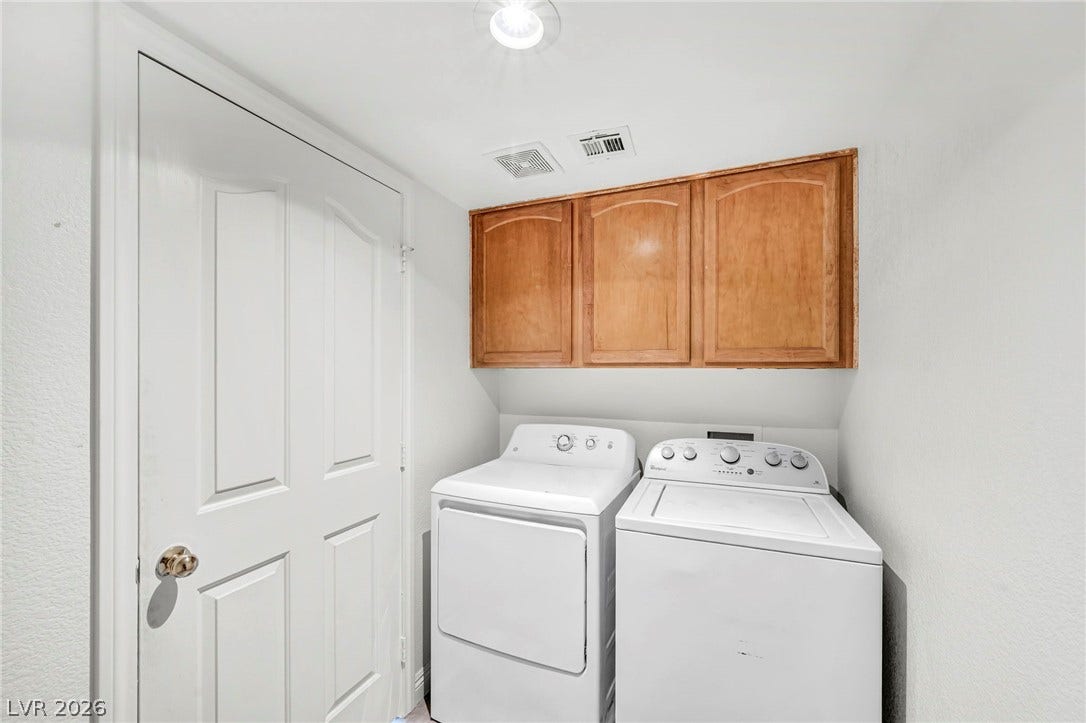 511 Armenian Place, Henderson, NV 89052 A dedicated laundry space features overhead wood cabinetry and direct outdoor access.