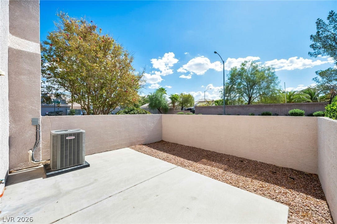 511 Armenian Place, Henderson, NV 89052 An enclosed concrete patio area provides a private outdoor retreat beneath open sunny skies.