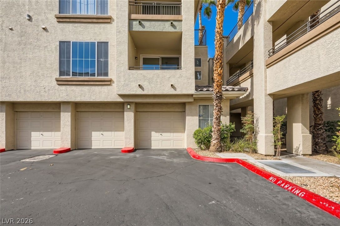 7173 S Durango Drive, #212, Las Vegas, NV 89113 Stucco exteriors and multiple garages define this modern multi-level residential facade.
