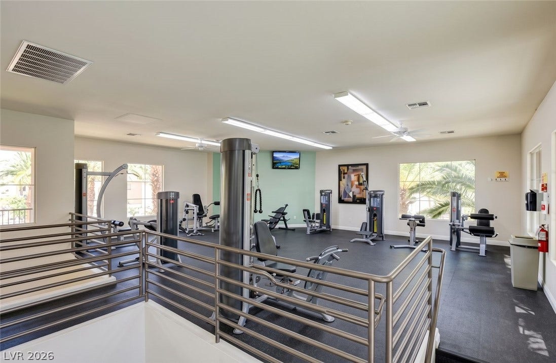 7173 S Durango Drive, #212, Las Vegas, NV 89113 Industrial flooring and protective metal railings define this well-appointed community workout space.
