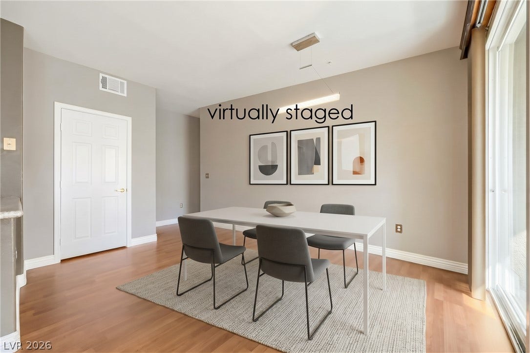 7173 S Durango Drive, #212, Las Vegas, NV 89113 Gleaming hardwood floors and a sliding glass door define this inviting dining space.