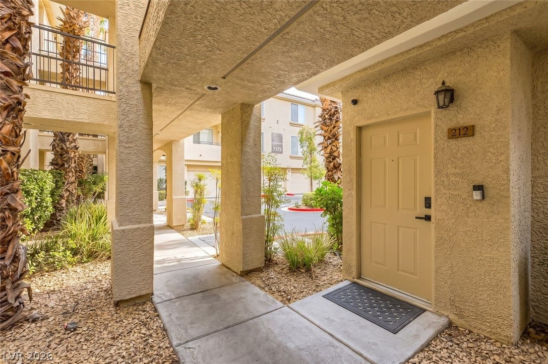 7173 S Durango Drive, #212, Las Vegas, NV 89113 Welcoming covered walkway guides visitors directly to the secure private entrance of this residence.