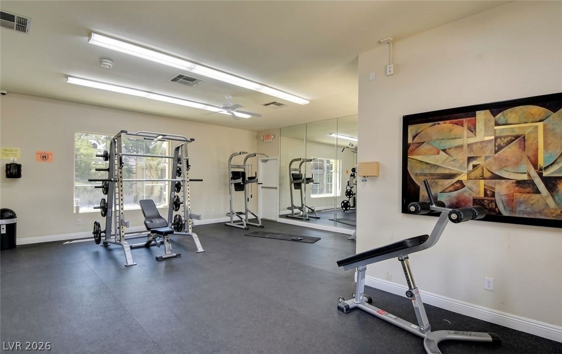 7173 S Durango Drive, #212, Las Vegas, NV 89113 Mirrored walls and durable flooring define this functional home exercise space.